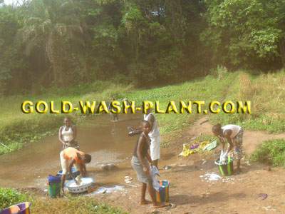 Residents in the mining area washing clothes in the river